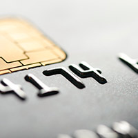 Close up of credit card numbers and EMV chip.